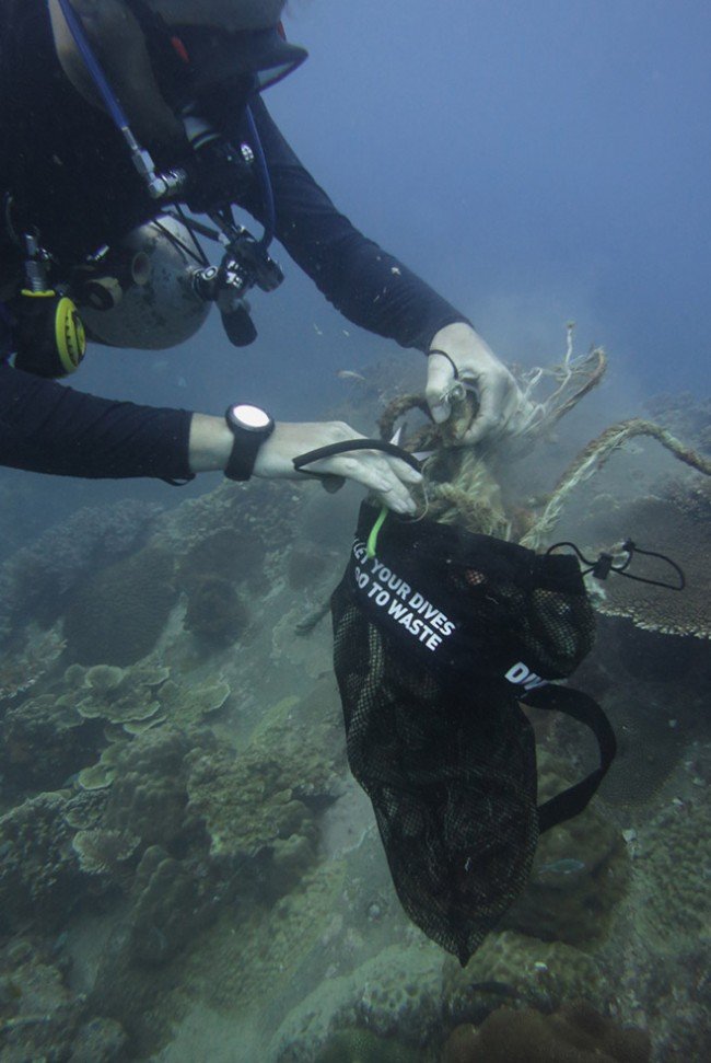 Stuffing mesh bags with trash