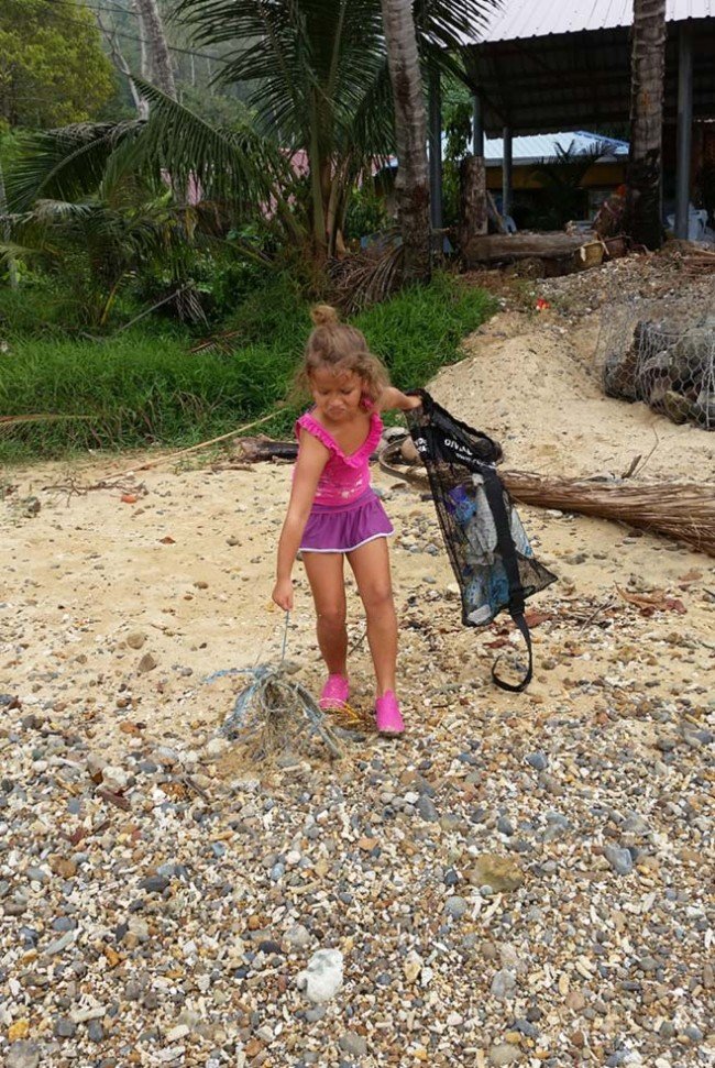Sasha is not impressed with all the trash on her beach