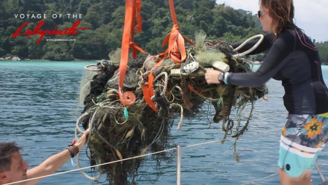 Hoisting collected debris onto the yacht