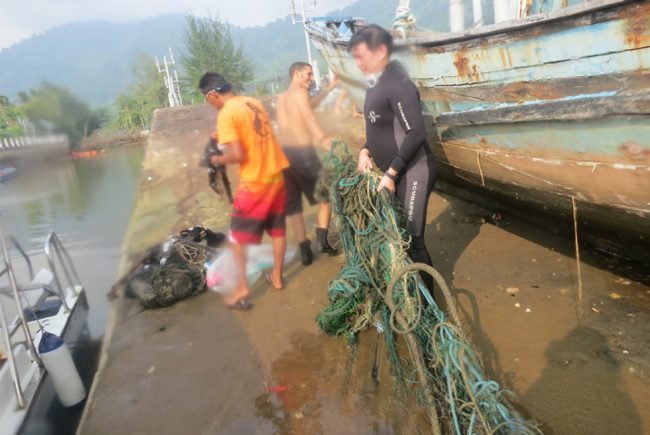 Dragging the haul up Tekek jetty for responsible disposal